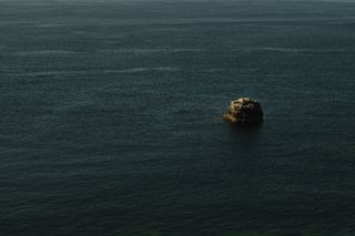 An emerging rock in the sea