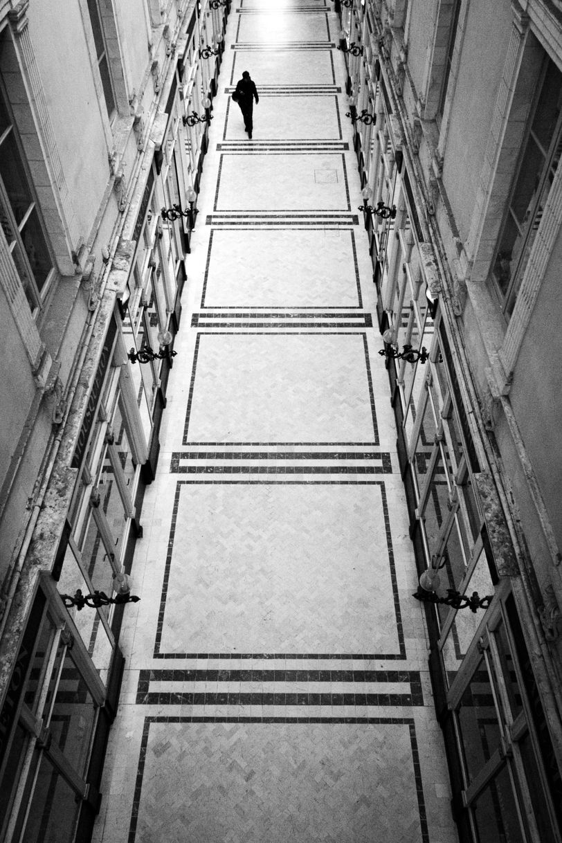 View from above of a long classy hallway and one person walking it