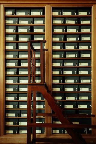 Shelf of archives and movable stairs in front of it
