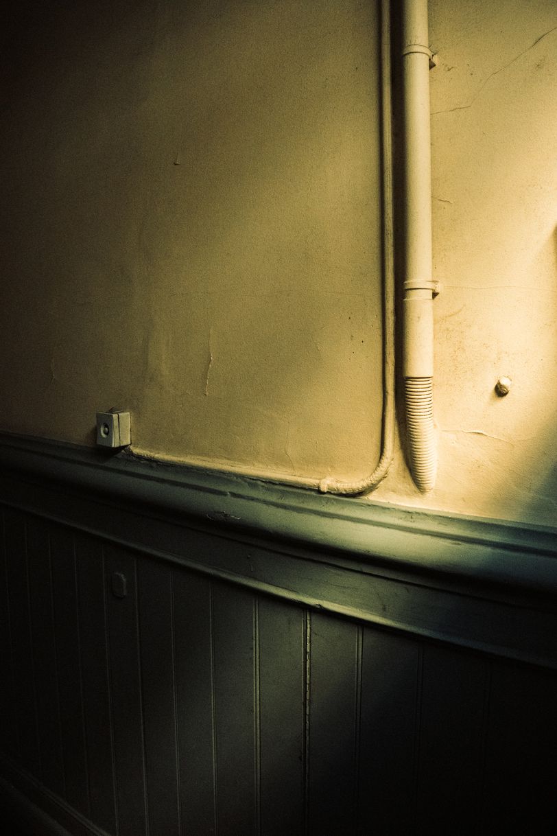 Slightly enlighted wall in a closed corridor