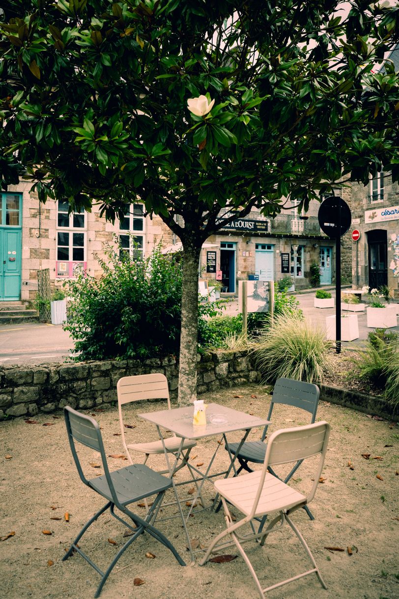 Charming place with a table and chairs in the middle of a rustic town center