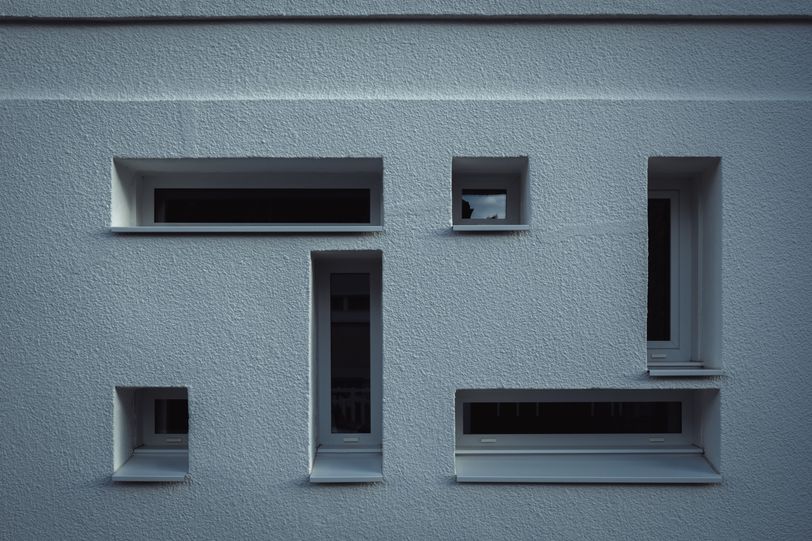 Chaotic disposition of different shapes of windows on a wall