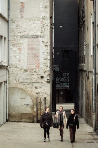 Three ladies walking proudly in the street together