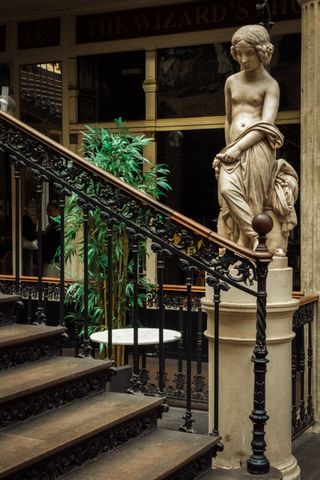 Classical statue next to stairs