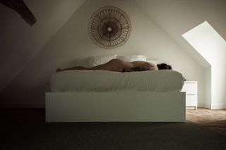 Myself laid down on a bed, naked