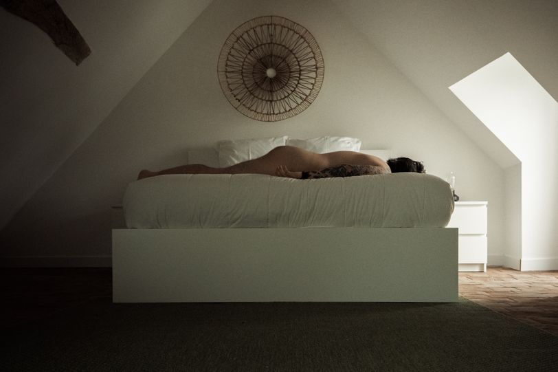 Myself laid down on a bed, naked