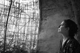 Portrait of a woman looking at a deconstructed wall