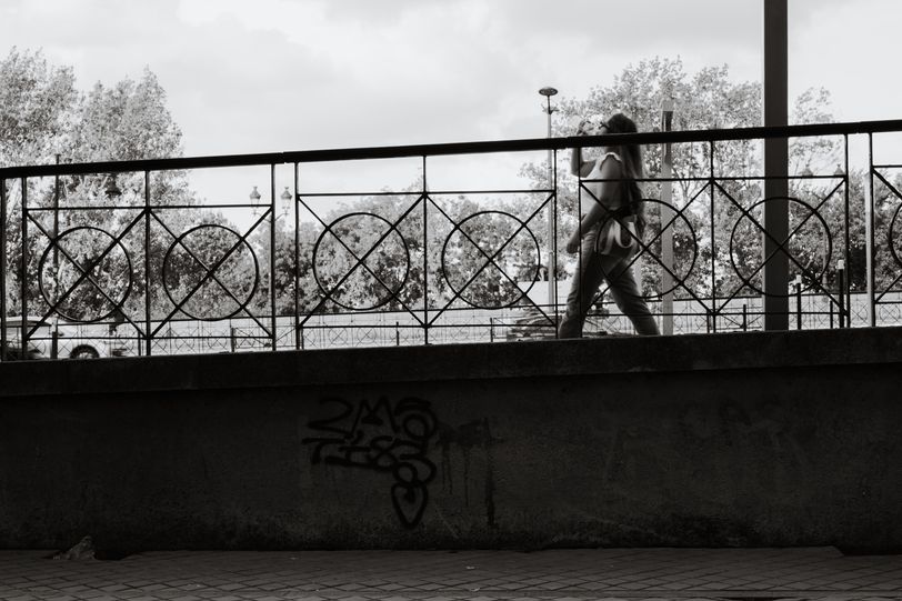 A woman walking on a descending sidewalk