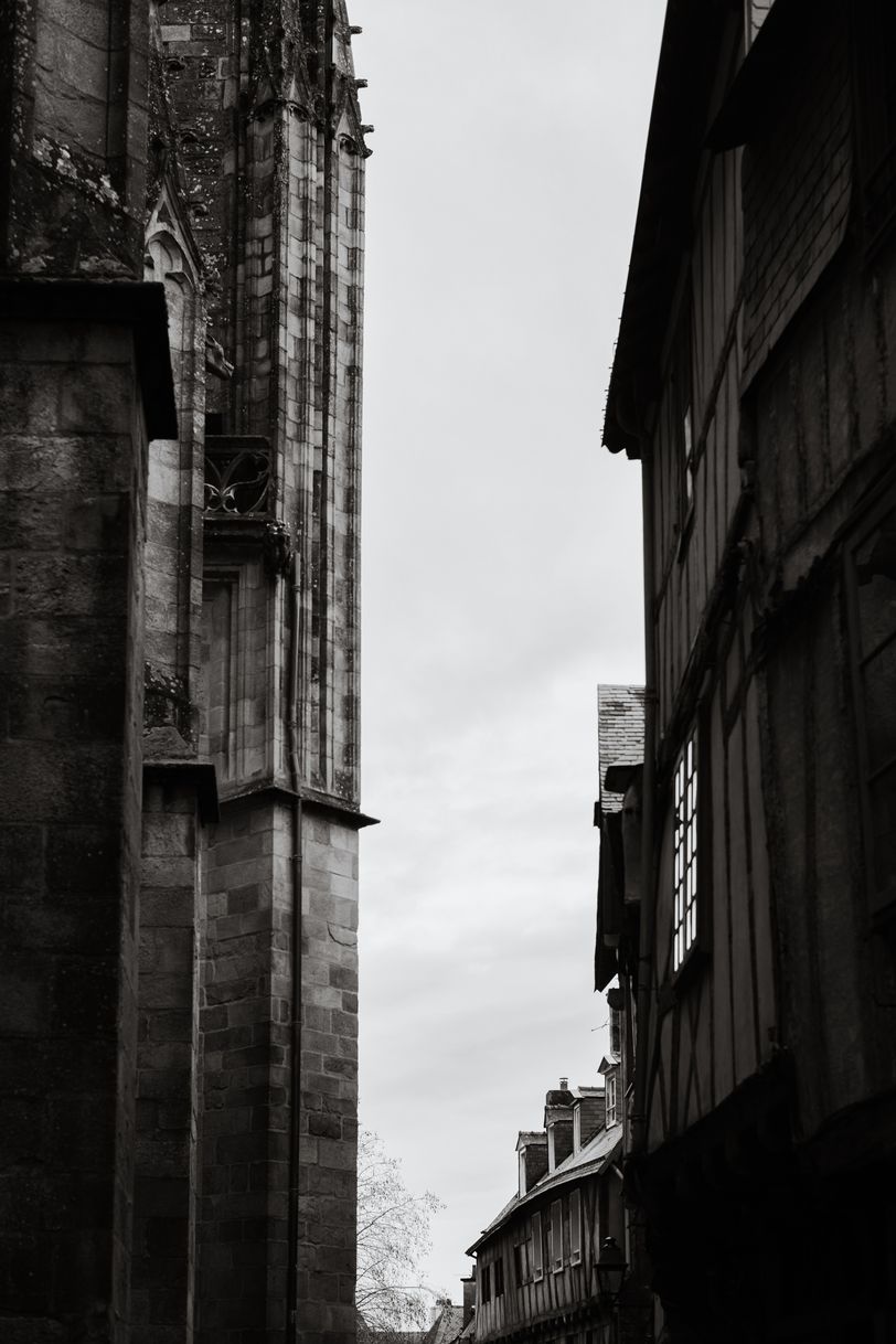 A church facade in front of old houses facades