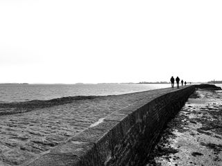 A family walking to the end of a pier