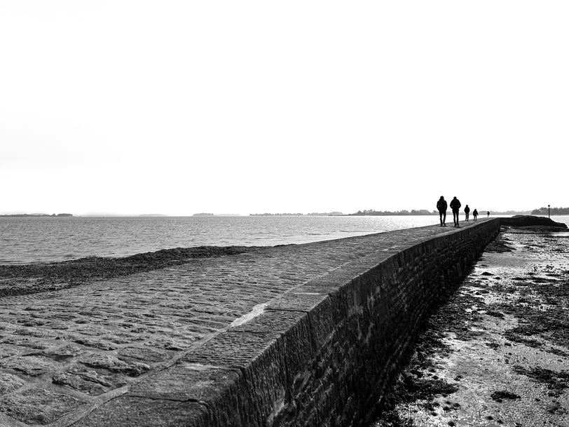 A family walking to the end of a pier