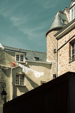 A clothes hanging thread between building with different architecture