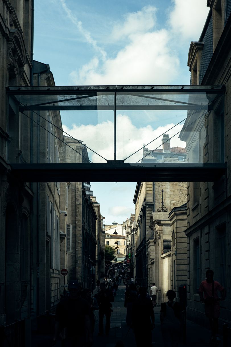 Glass corridor passing above a pedestrian street in the city