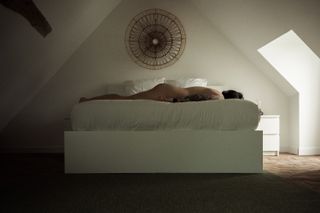 Myself laid down on a bed, naked