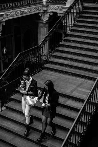 Two women going down an old staircase