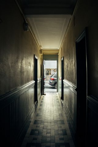 Dark small hallway going towards the light