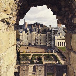 Framed castle within the window of an older castle