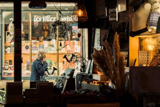 View on passing person in a pedestrian street from inside a store