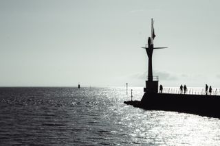 View on the sea and a bit of land where a lighthouse stands