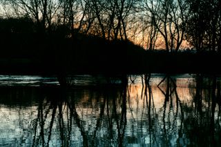 An overflowing river on sunset