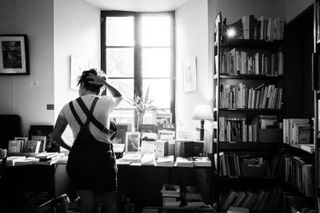 A woman looking at books in a library