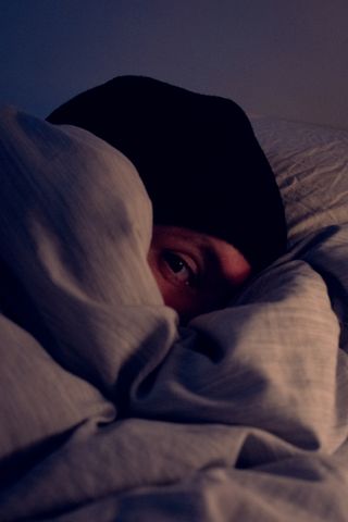 Myself bundled up in my bed while resting from my cold