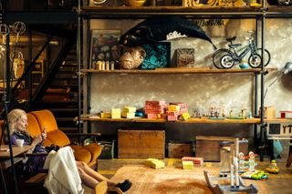 An old lady sitting in a children playroom