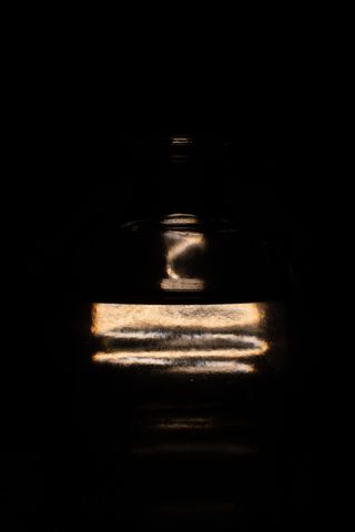 Abstract picture of a lighbulb behind a bottle of water