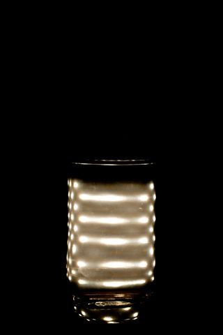 Light bulb behind a jar of water