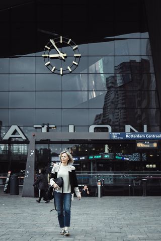 A woman coming out of a train station at 8h54