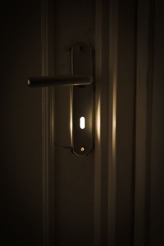 Sunlight coming out of a door's keyhole