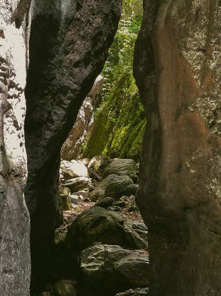 A brighter path beyond a passage between two big rocks