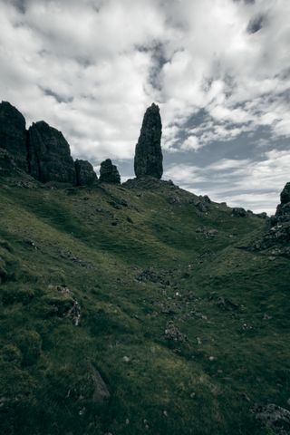 Pointy outgrowth of rocks up on a grassy hill