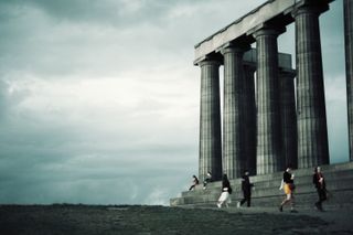 An unfinished antics-like monument facing the emptyness of a cloudy sky