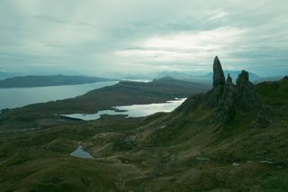 Landscape of a massive pointy rock on top of a mountain in the Highlands early in the morning