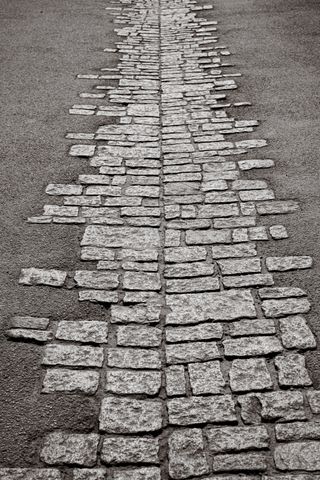 Partially paved road around a symmetrical axe