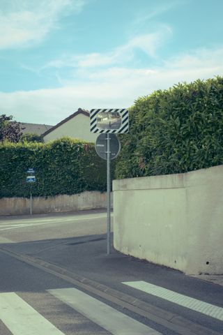 An empty street with a traffic mirror