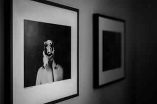 Framed pictures on a wall in black and white