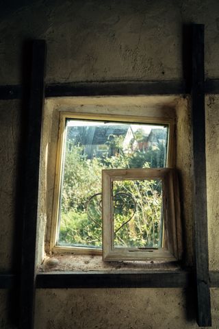 View from inside a house on a framed window before a little frame