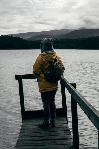 A person watching a lake on a crooked pontoon