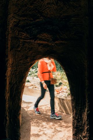 View from inside a hut of a person walking by the door