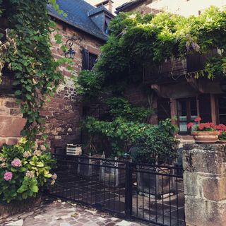 A flowery small house made of red bricks