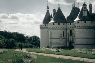 A couple walking by a Renaissance castle