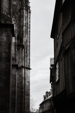 A church facade in front of old houses facades