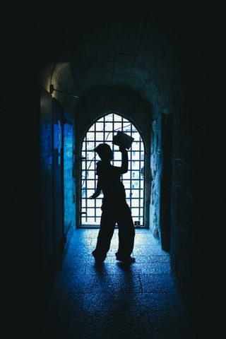 Backlight of a woman in tunnel with light at the end