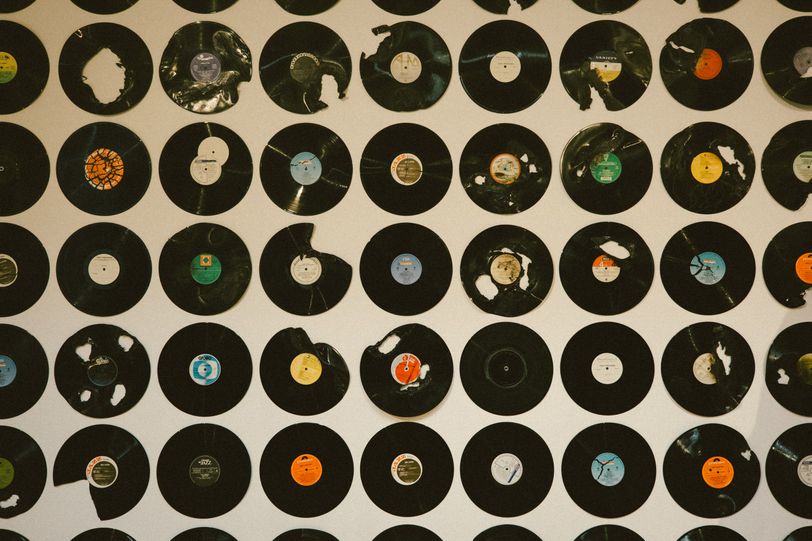 A wall covered in vinyl discs in different conditions