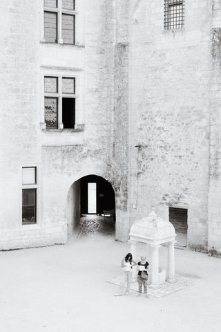 Two people watching their map inside an old building