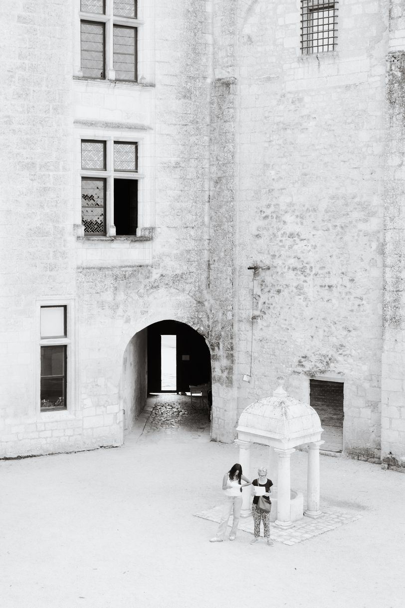 Two people watching their map inside an old building
