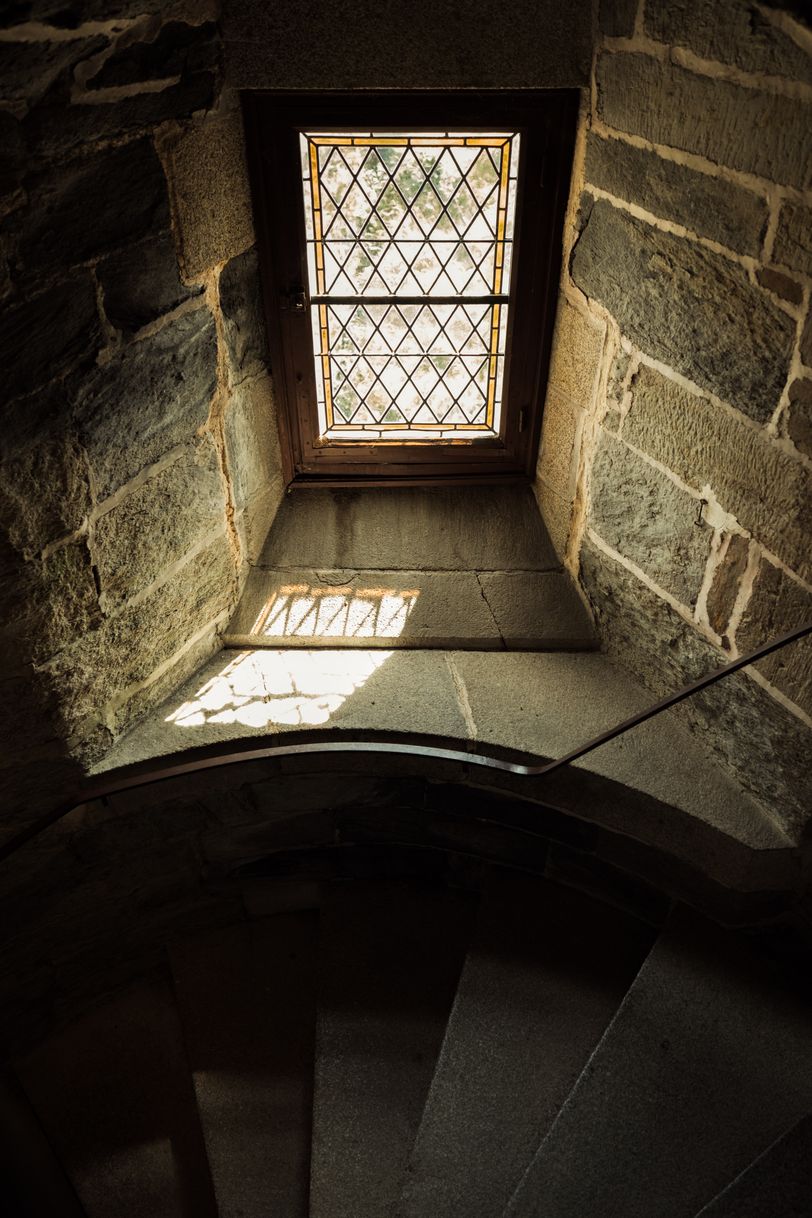 Staircase in a medieval castle lit by a small window