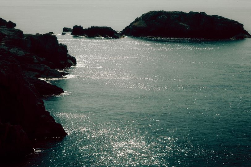 Shores in the morning with the sun reflecting on the sea